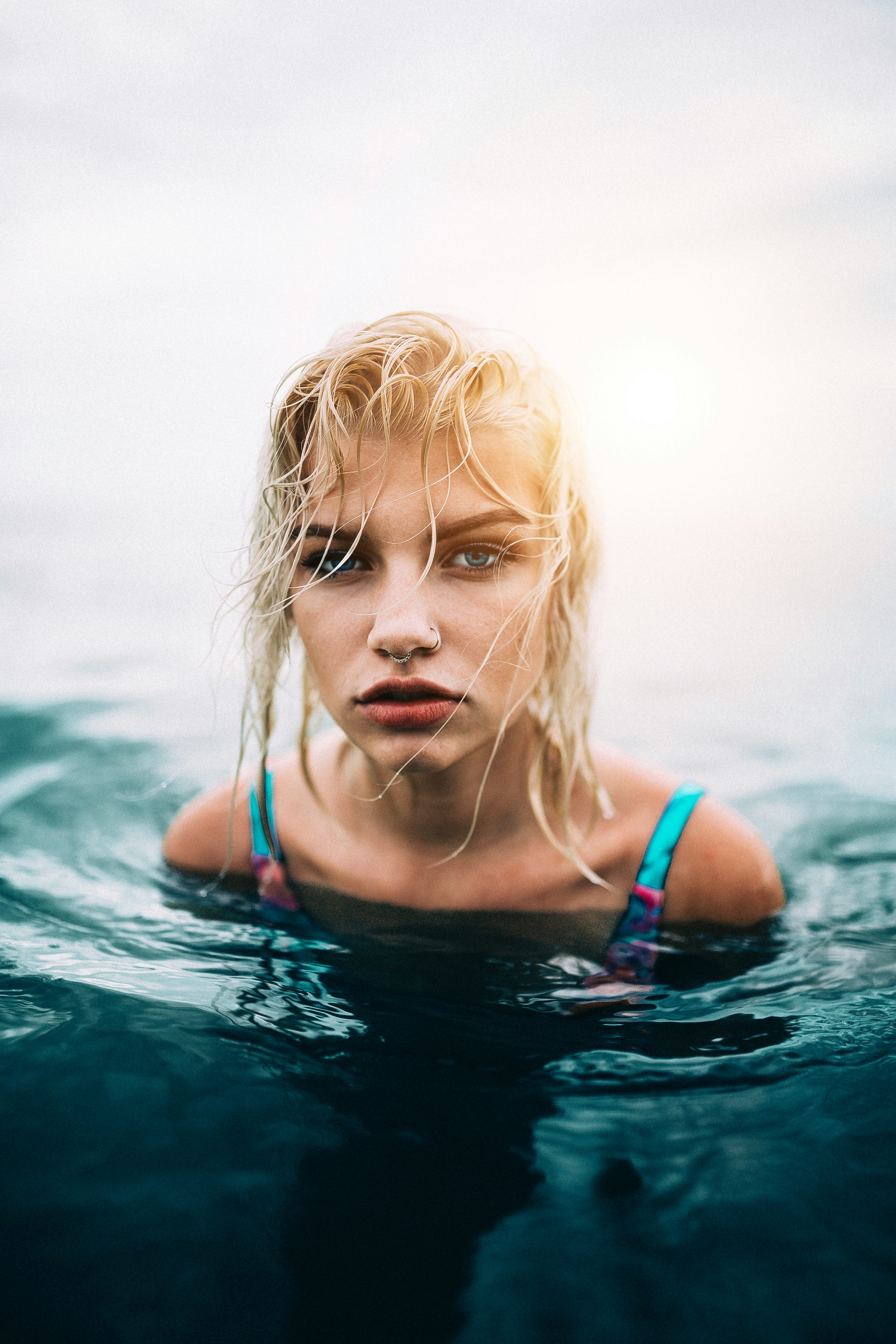 woman wearing blue swimsuit on the body of water